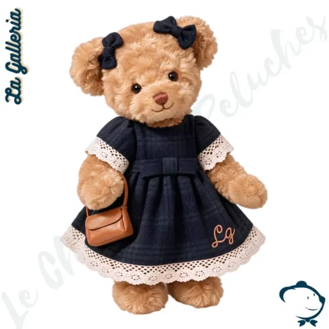 Kate, oursonne en peluche La Galleria Signature British de 30 cm, avec robe bleu marine à dentelle blanche, nœuds assortis et petit sac marron.