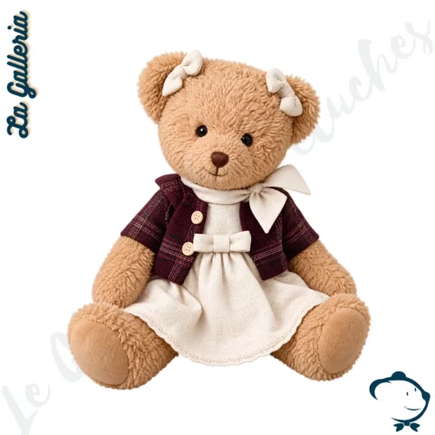 Romy, oursonne en peluche La Galleria de 30 cm au pelage blond doré, vêtue d'une robe écrue, d'une veste bordeaux et de petits nœuds crème.